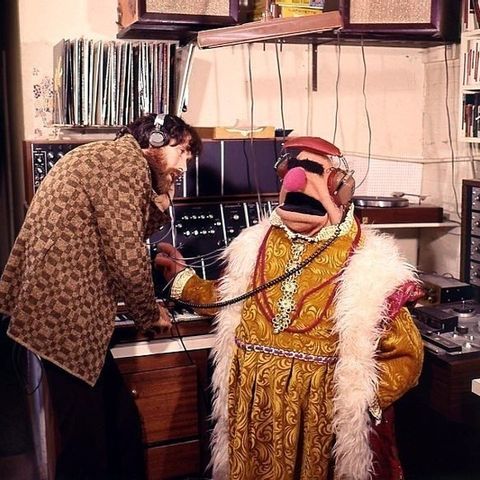 Jim Henson and one of his man-sized puppets, listening to records.