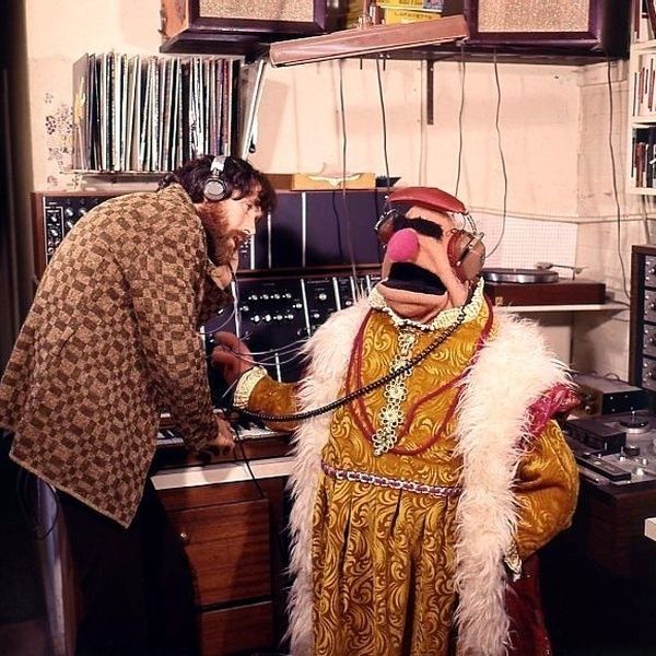 Jim Henson and one of his man-sized puppets, listening to records.